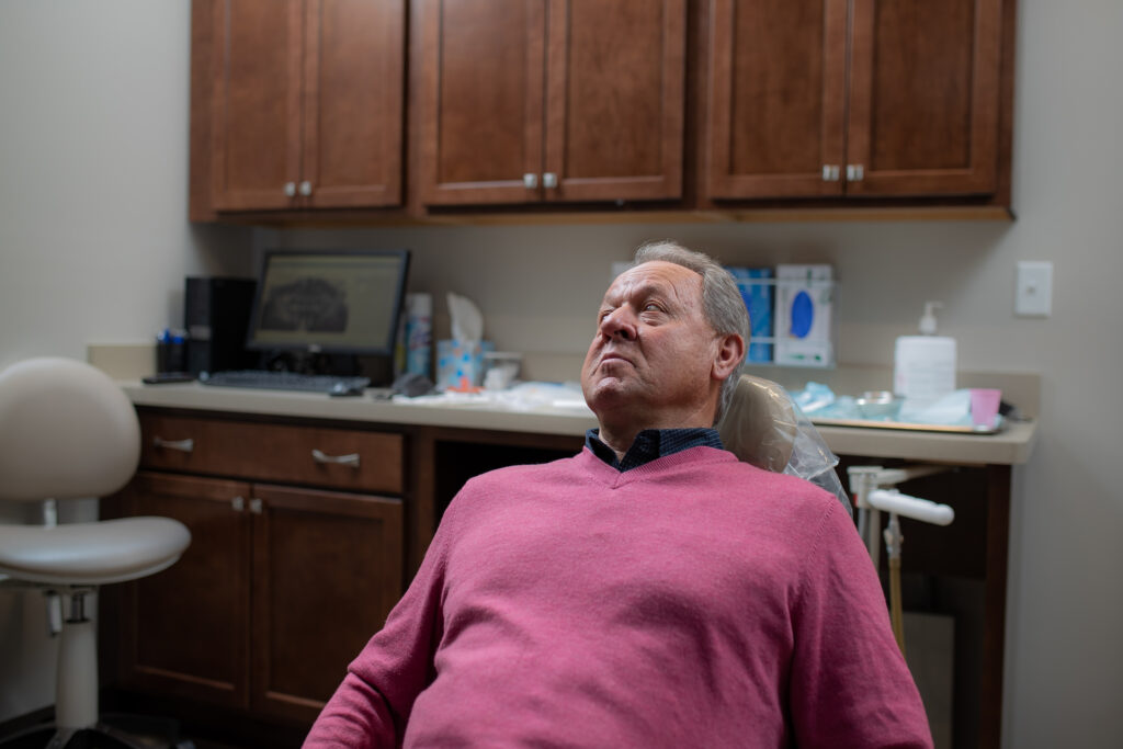 surgical patient sitting in the chair listening to the surgeon