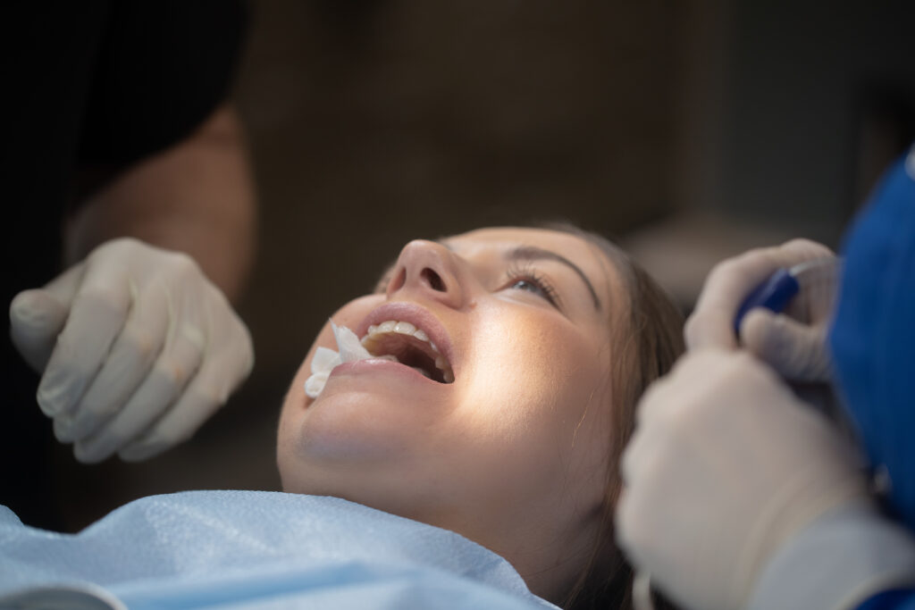 patient with gauze in her mouth after surgical procedure