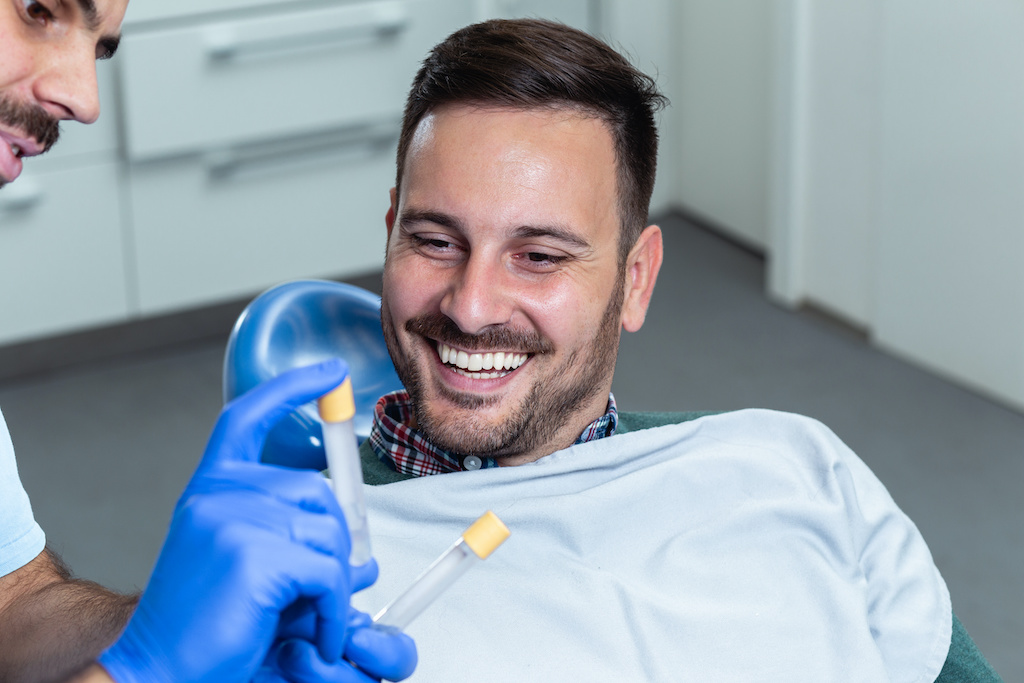 doctor showing patient vial of platelet rich plasma