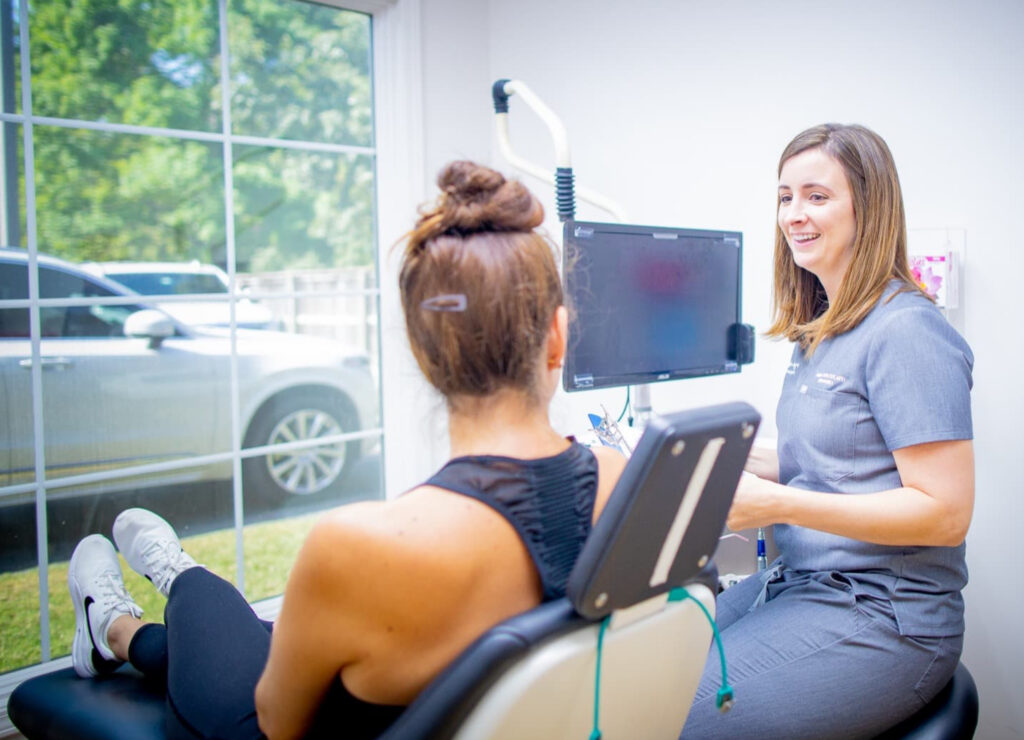 Washington Oral & Facial Surgery employee discussing procedures with a patient