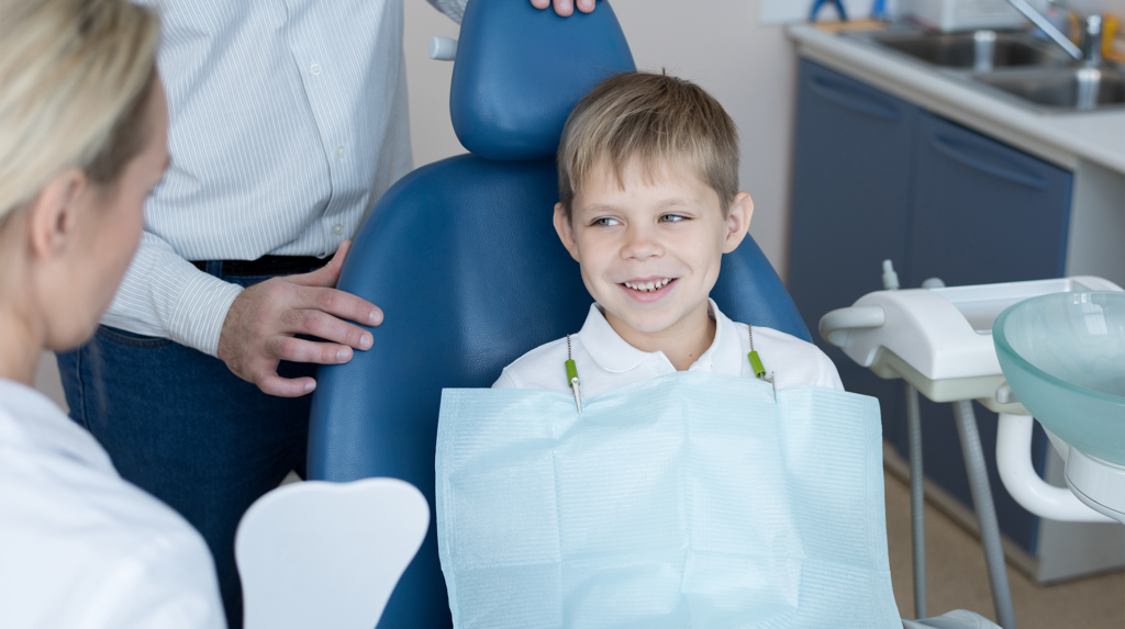 young boy sitting in the dental chair