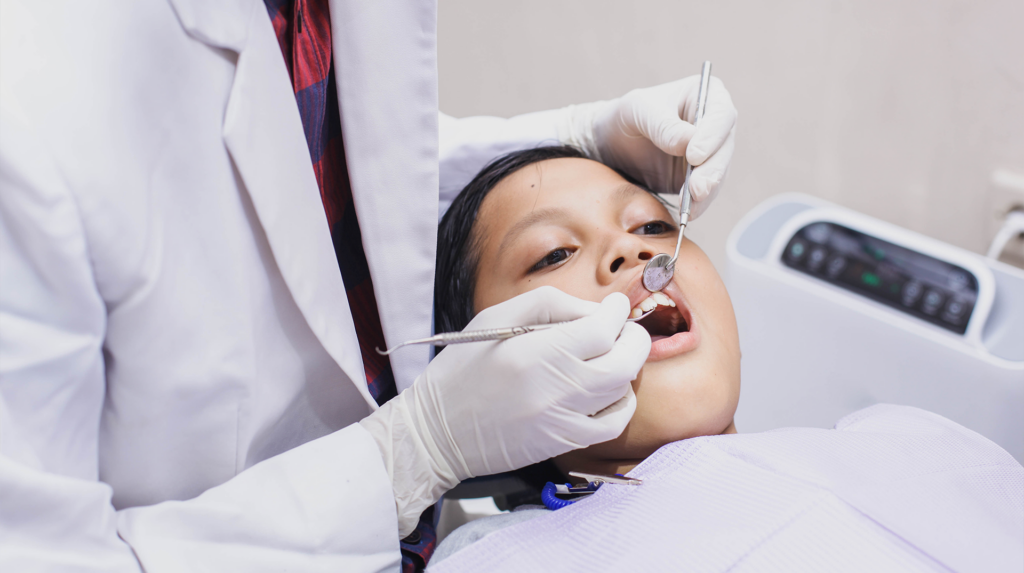 child having teeth examined