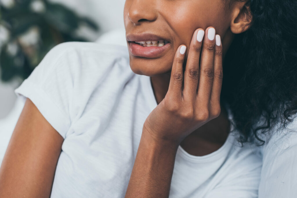 young woman suffering from jawbone pain